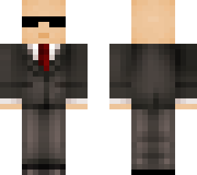 bald man in a suit (with sunglasses) read description