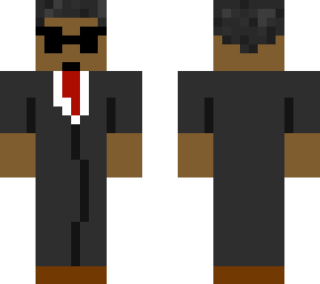 man in suit with sunglasses and red tie and leather boots